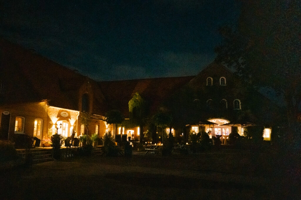 Beleuchtete Hochzeitslocation bei Nacht.